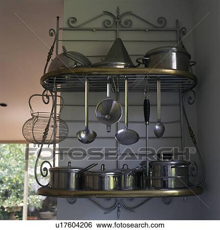 Close-up of stainless steel saucepans on ornate metal shelves View Large Photo Image Stock Photograph - Close-up of stainless steel saucepans on ornate metal shelves. Fotosearch