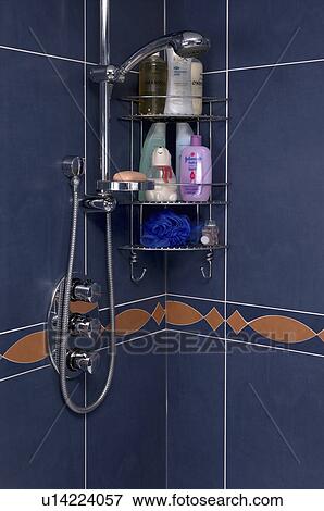 Stock Photo - Close-up of stainless steel shower-head and toiletries on shelves. Fotosearch