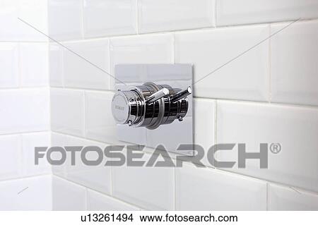 Picture - Close-up of stainless steel shower tap. Fotosearch