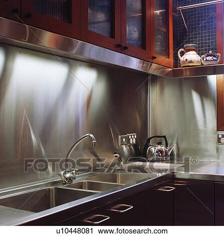 Close-up of stainless steel splashback above steel sink and worktop View Large Photo Image Stock Image - Close-up of stainless steel splashback above steel sink and worktop. Fotosearch