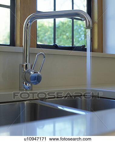 Close-up of stainless steel tap pouring water into steel sink View Large Photo Image Stock Image - Close-up of stainless steel tap pouring water into steel sink. Fotosearch