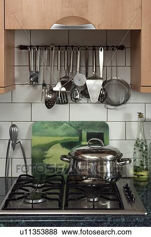 Close-up of stainless steel utensils on rack above gas hob with stainless steel pan View Large Photo Image Stock Photo - Close-up of stainless steel utensils on rack above gas hob with stainless steel pan. Fotosearch