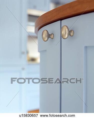 Stock Photo - Close-up of steel handles on pastel blue kitchen unit. Fotosearch