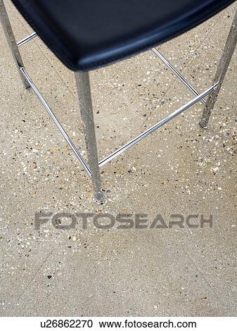 Close-up of stool on concrete flooring View Large Photo Image Stock Image - Close-up of stool on concrete flooring. Fotosearch