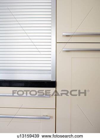 Close-up of tambour shutter in white kitchen cupboard View Large Photo Image Stock Photo - Close-up of tambour shutter in white kitchen cupboard. Fotosearch