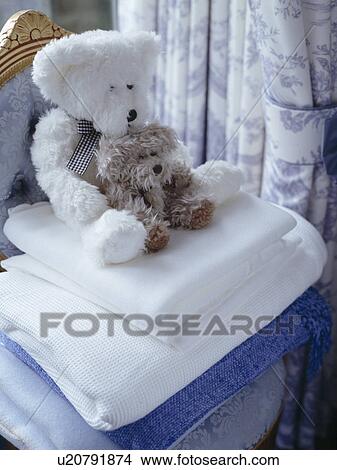 Picture - Close-up of teddybears on pile of white blankets. Fotosearch