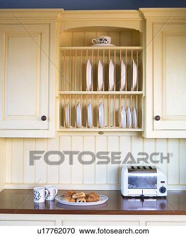 Close Up Of Toaster On Worktop Below Integral Plate Rack In Cream