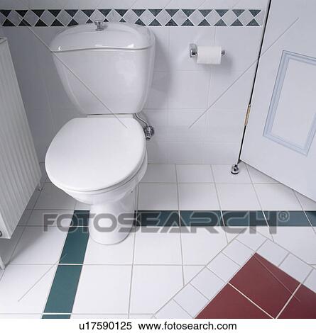 Stock Photography - Close-up of toilet and patterned tiled floor. Fotosearch