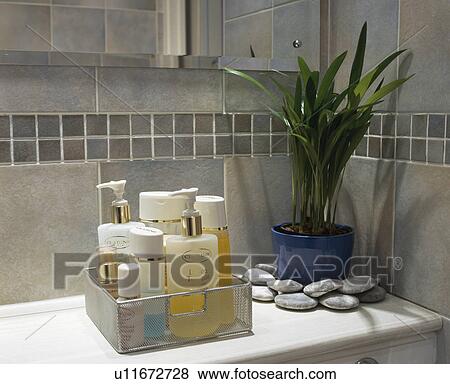 Close-up of toiletries in glass container beside houseplant View Large Photo Image Stock Photo - Close-up of toiletries in glass container beside houseplant. Fotosearch