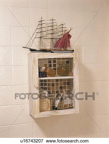 Stock Photo - Close-up of toy boat on small white shelf unit. Fotosearch