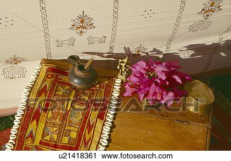 Close-up of traditional Rajastani embroidered cloth and pink rhododendrons in vase on wooden table in tent View Large Photo Image Stock Image - Close-up of traditional Rajastani embroidered cloth and pink rhododendrons in vase on wooden table in tent. Fotosearch