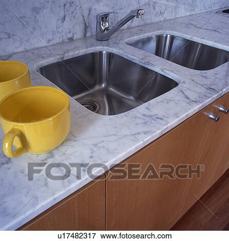 Close Up Of Underset Double Stainless Steel Sink In Grey Granite