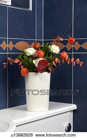 Close-up of vase of red flowers against black wall tiles View Large Photo Image Stock Photograph - Close-up of vase of red flowers against black wall tiles. Fotosearch