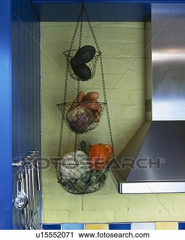 Stock Image - Close-up of vegetables in metal storage baskets. Fotosearch