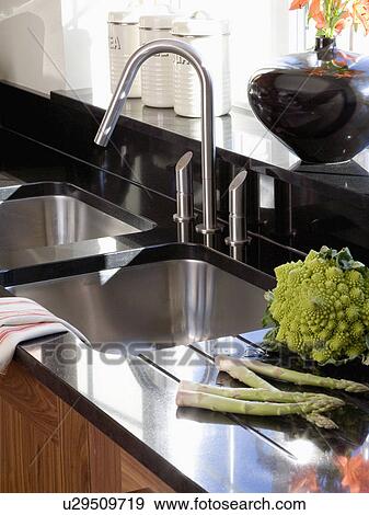 Close-up of vegetables on draining board beside stainless steel mixer tap and underset steel sink View Large Photo Image Stock Photo - Close-up of vegetables on draining board beside stainless steel mixer tap and underset steel sink. Fotosearch
