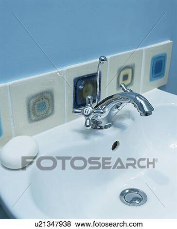 Close-up of wall tiles above chrome tap and white basin View Large Photo Image Stock Photo - Close-up of wall tiles above chrome tap and white basin. Fotosearch