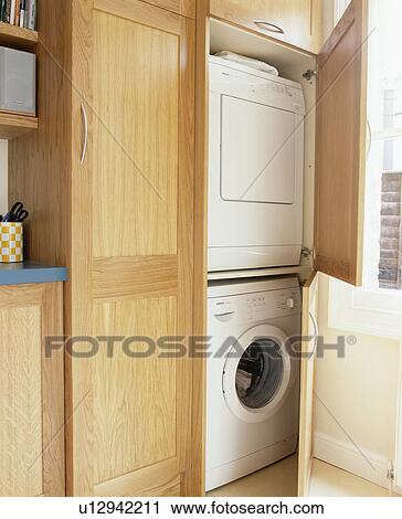 Close-up of washing-machine and tumble-dryer concealed behind wood doors View Large Photo Image Stock Image - Close-up of washing-machine and tumble-dryer concealed behind wood doors. Fotosearch