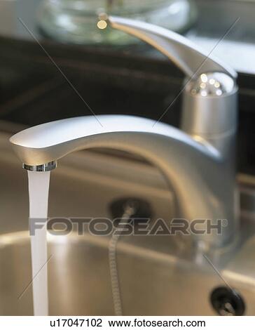 Close-up of water pouring from stainless steel tap View Large Photo Image Stock Image - Close-up of water pouring from stainless steel tap. Fotosearch