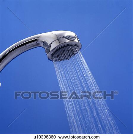 Stock Image - Close-up of water spraying from chrome shower head. Fotosearch