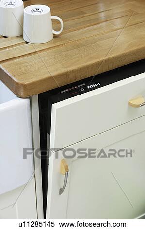 Close-up of white cups on worktop above white dishwasher View Large Photo Image Stock Photography - Close-up of white cups on worktop above white dishwasher. Fotosearch
