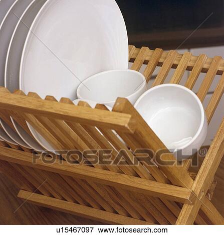 Close-up of white plates and bowls on wooden plate-rack View Large Photo Image Stock Photo - Close-up of white plates and bowls on wooden plate-rack. Fotosearch