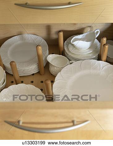 Close-up of white plates and sauceboat in storage drawer View Large Photo Image Stock Photo - Close-up of white plates and sauceboat in storage drawer . Fotosearch