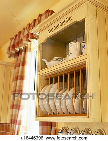 Stock Photograph - Close-up of white plates on fitted wooden plate rack . Fotosearch