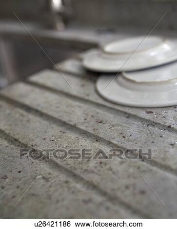 Close-up of white plates on grey granite draining board View Large Photo Image Stock Photograph - Close-up of white plates on grey granite draining board. Fotosearch