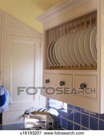 Close-up of white plates on plate rack with storage drawers View Large Photo Image Stock Photo - Close-up of white plates on plate rack with storage drawers. Fotosearch
