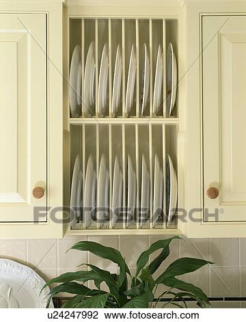 Close-up of white plates on rack in fitted cream unit View Large Photo Image Stock Image - Close-up of white plates on rack in fitted cream unit. Fotosearch