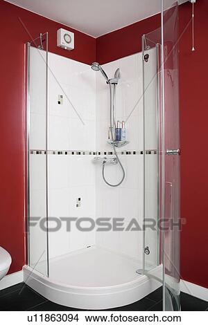 Picture - Close-up of white tiled shower cabinet with perspex doors. Fotosearch