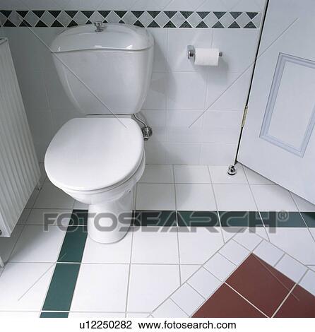 Close-up of white toilet and white and green tiled floor View Large Photo Image Stock Image - Close-up of white toilet and white and green tiled floor. Fotosearch