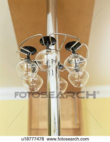 Stock Photo - Close-up of wine glasses stored on metal rack on stainless steel pole. Fotosearch
