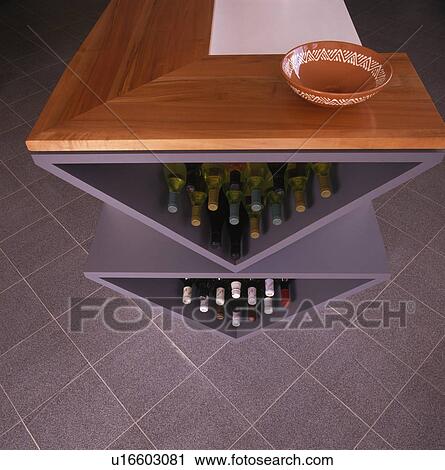 Close-up of wine storage in fitted kitchen unit View Large Photo Image Stock Image - Close-up of wine storage in fitted kitchen unit. Fotosearch