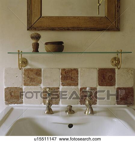 Close-up of wooden-framed mirror and glass shelf above brown+cream tiles View Large Photo Image Stock Photo - Close-up of wooden-framed mirror and glass shelf above brown+cream tiles. Fotosearch