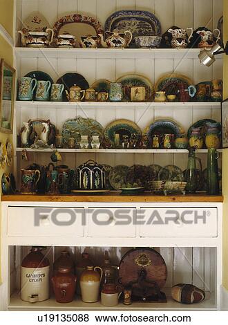 Collection of antique Majoloica ware on white Victorian dresser View Large Photo Image Stock Photo - Collection of antique Majoloica ware on white Victorian dresser. Fotosearch