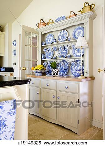 Collection Of Blue White China On Painted Kitchen Dresser Stock