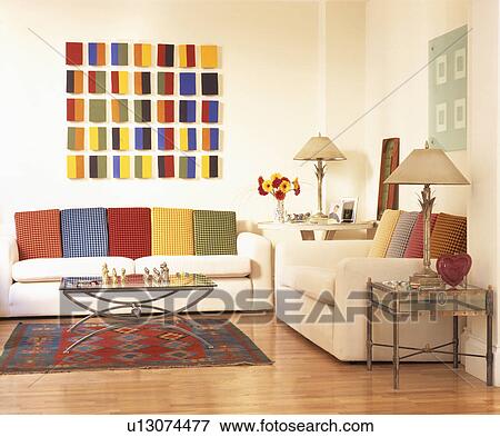 Colourful cushions on white sofas in modern white living room with abstract picture View Large Photo Image Stock Photo - Colourful cushions on white sofas in modern white living room with abstract picture. Fotosearch