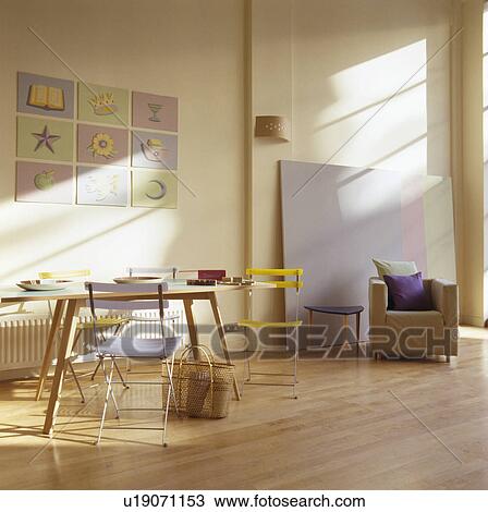 Stock Image - Comfortable armchair and wooden flooring in modern loft conversion. Fotosearch