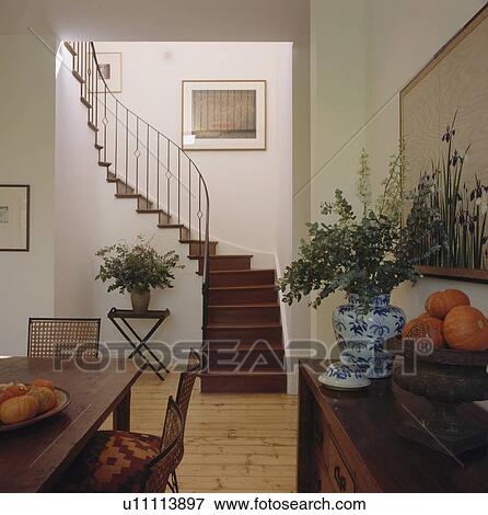 Picture Of Console Table And Dining Chairs In Modern Hall Console Table And Dining Chairs In Modern Hall With Curved Wooden Stairs