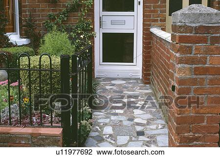 Crazy paving path to white UPVC front door of small house View Large Photo Image Stock Image - Crazy paving path to white UPVC front door of small house. Fotosearch