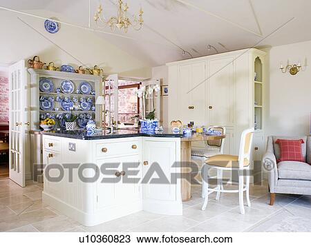 Cream chair at breakfast bar on island unit in cream country kitchen View Large Photo Image Stock Image - Cream chair at breakfast bar on island unit in cream country kitchen. Fotosearch