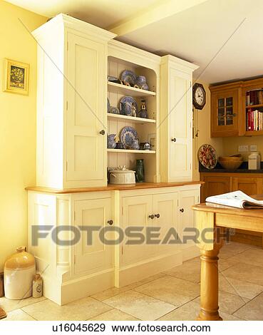 Cream Fitted Dresser In Yellow Country Kitchen Stock Photo
