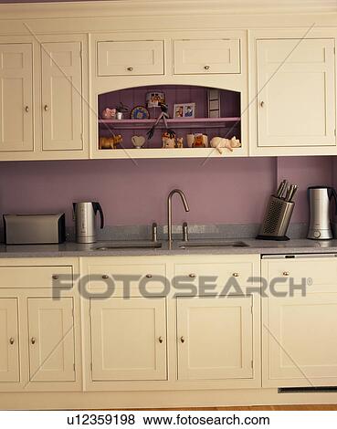 Cream fitted units in mauve kitchen View Large Photo Image Stock Photo - Cream fitted units in mauve kitchen. Fotosearch