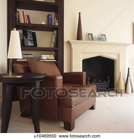 Cream Lamp On Table Beside Brown Leather Armchair In Cream Living