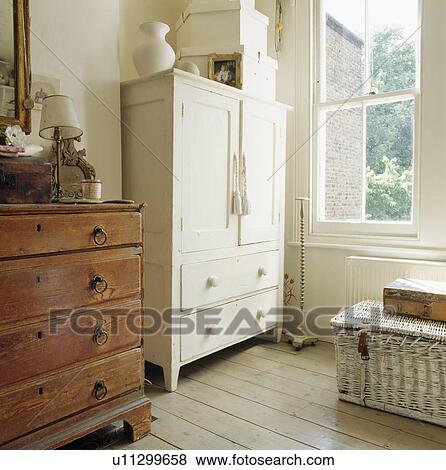 Cream Painted Linen Press And Antique Chest Of Drawers In Front Of
