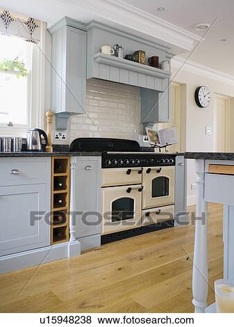 Cream range oven in kitchen with pale blue units and wooden flooring View Large Photo Image Stock Photo - Cream range oven in kitchen with pale blue units and wooden flooring. Fotosearch