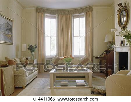 Stock Photography - Cream sofas in traditional cream townhouse living room. Fotosearch
