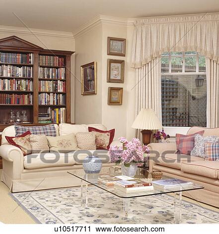 Cream Sofas Piled With Cushions In Traditional Neutral Living Room Cream Sofas Piled With Cushions In