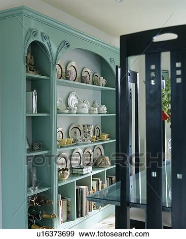 Crockery displayed on fitted turquoise shelves View Large Photo Image Stock Photo - Crockery displayed on fitted turquoise shelves. Fotosearch